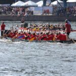 Team rowing a dragon boat during Ipswich Dragon Boat Race 2025 on the waterfront